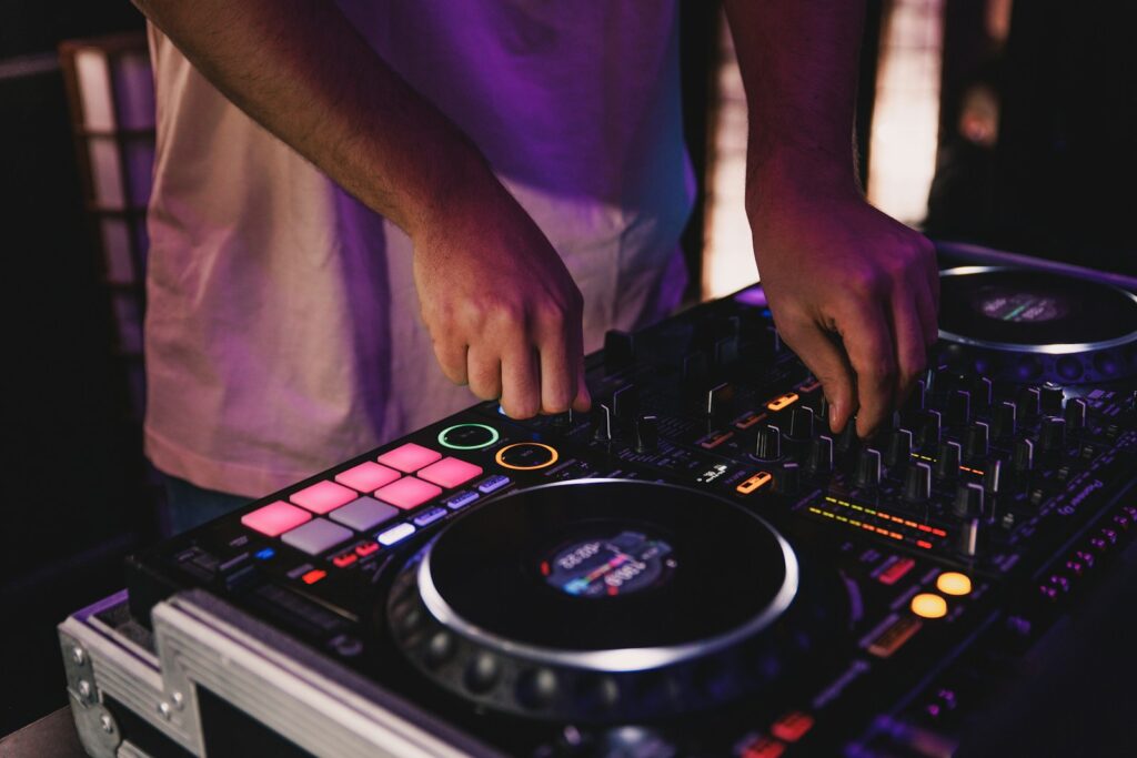 Dj hands mixing music on a console