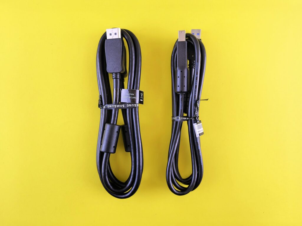 Two black cables coiled on a yellow background