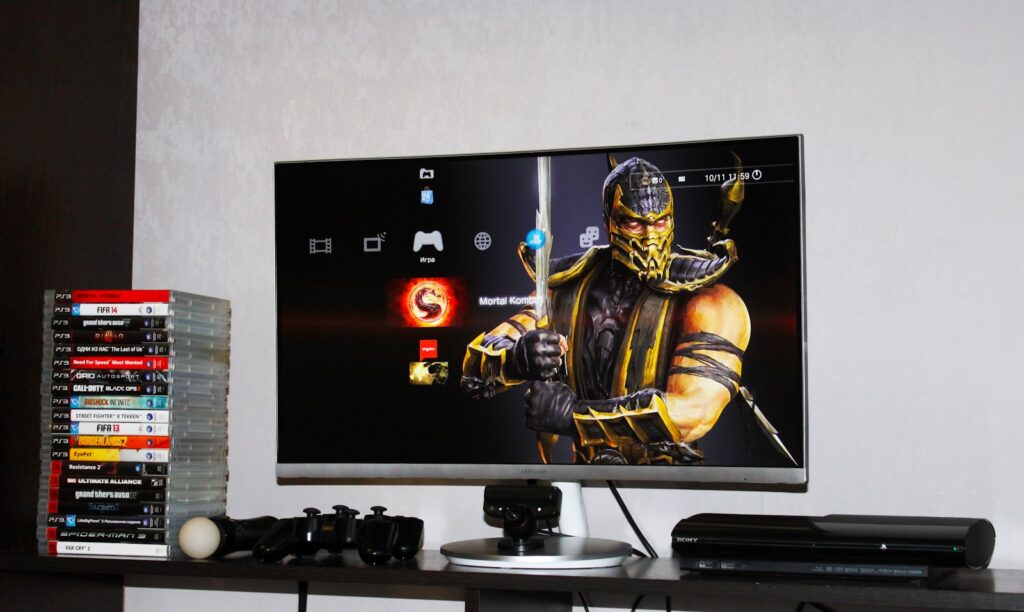flat screen monitor beside PS3 Super Slim