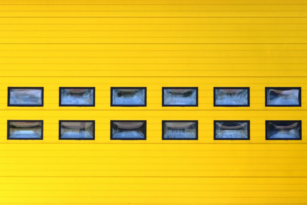 a yellow garage door with a bunch of windows