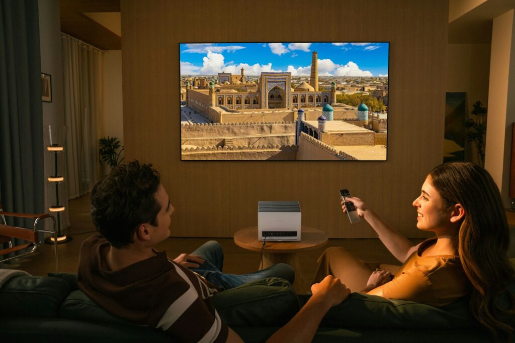 Couple watching a movie on a large screen television.